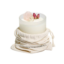 Load image into Gallery viewer, Peony blossom with rose quartz candle in branded cloth bag on a white background
