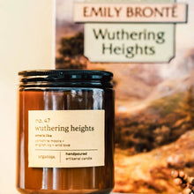 Load image into Gallery viewer, Candle labeled 'Wuthering Heights' in front of a book titled 'Wuthering Heights' by Emily Bronte.
