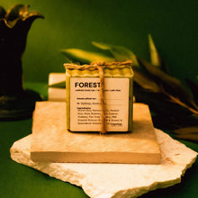 Load image into Gallery viewer, Bar of soap labeled 'Forest' on a stone surface with a green background
