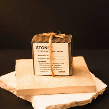 Load image into Gallery viewer, Bar of soap with a label 'STONE' on a stone surface against a dark background
